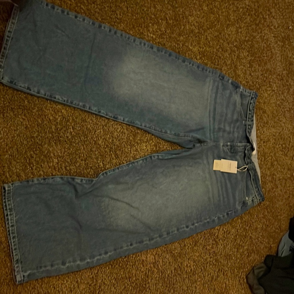 light-wash wide-leg mid-rise denim jeans with folded waistband